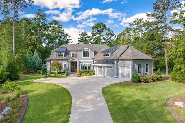 view of front of property with a garage and a front lawn