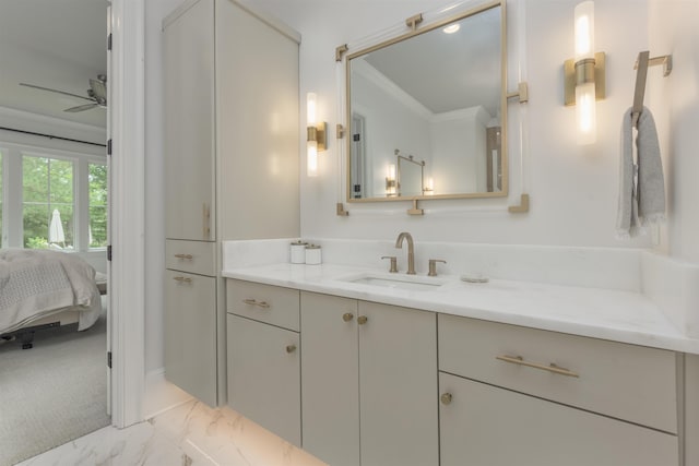 bathroom with crown molding, vanity, and ceiling fan