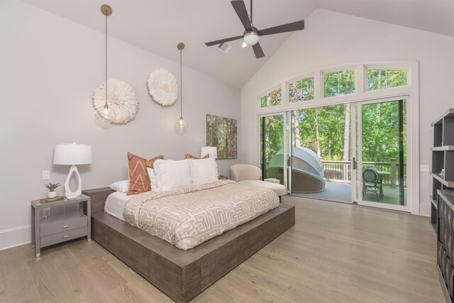 bedroom featuring access to exterior, high vaulted ceiling, and light hardwood / wood-style flooring