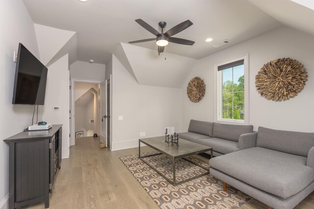 living room featuring hardwood / wood-style flooring, vaulted ceiling, and ceiling fan