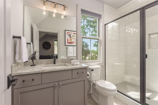 bathroom with vanity, an enclosed shower, and toilet