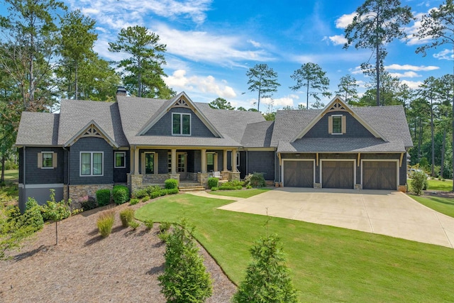 craftsman inspired home with a garage, covered porch, and a front lawn