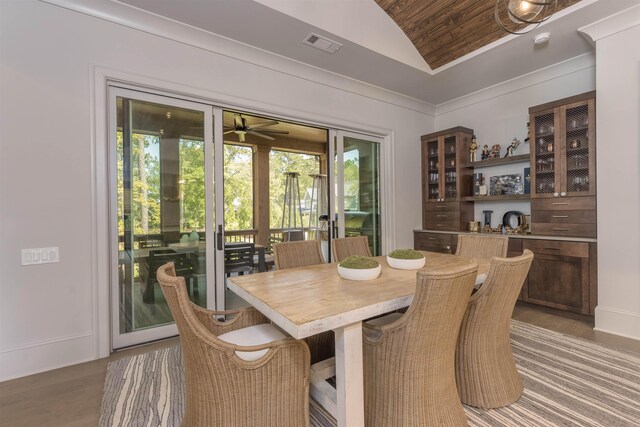 dining space featuring hardwood / wood-style flooring and vaulted ceiling