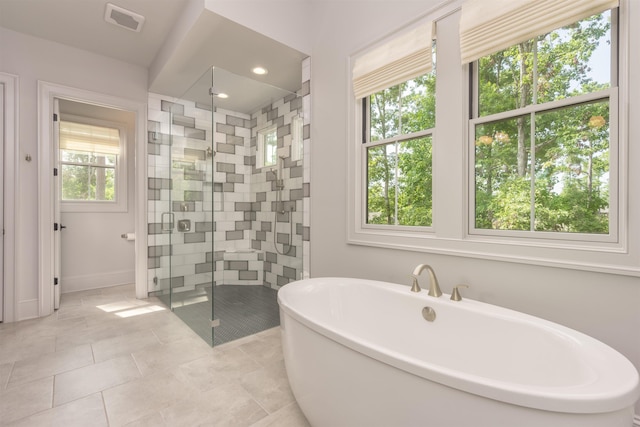 bathroom with tile patterned flooring and plus walk in shower