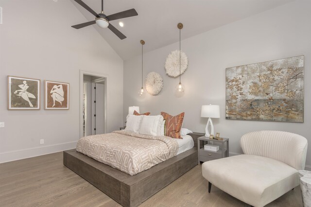 bedroom featuring hardwood / wood-style flooring, high vaulted ceiling, and ceiling fan