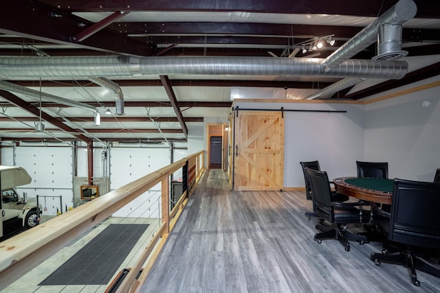 interior space featuring a barn door and hardwood / wood-style floors