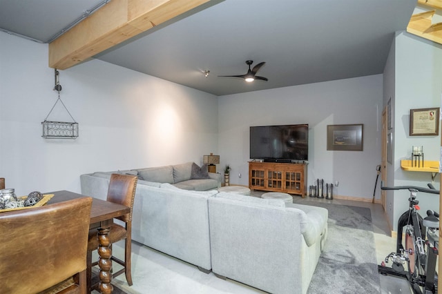 living room featuring beam ceiling and ceiling fan