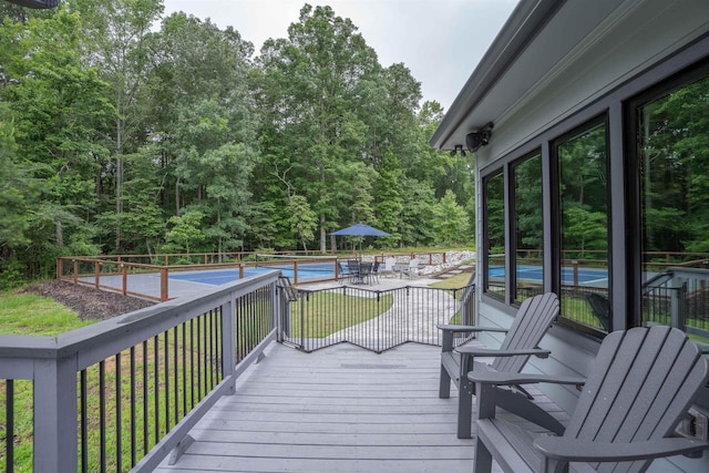 wooden terrace featuring a fenced in pool