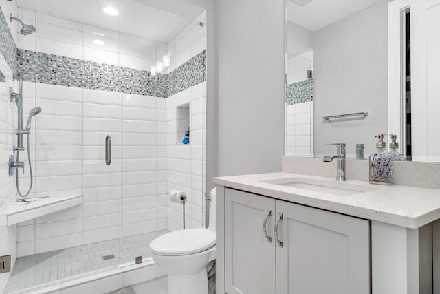 bathroom with vanity, toilet, and an enclosed shower