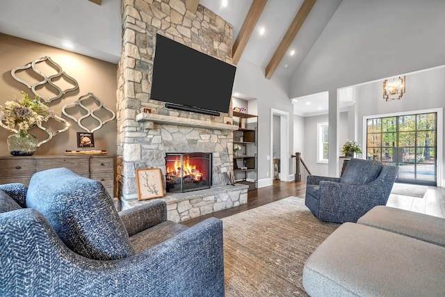 living room featuring beamed ceiling, wood-type flooring, a fireplace, and high vaulted ceiling