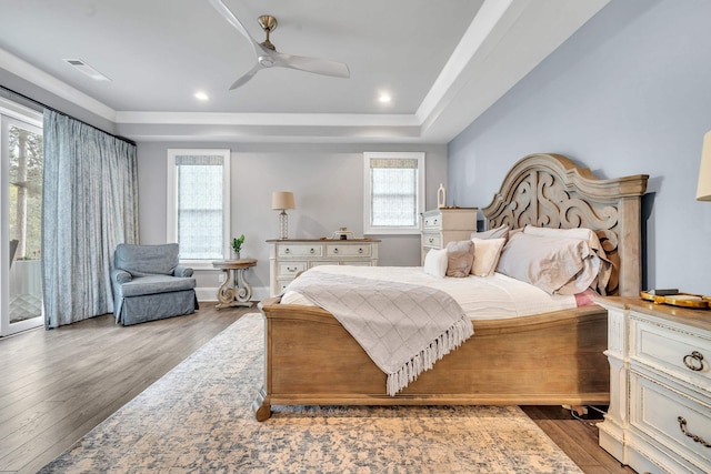 bedroom featuring a tray ceiling, access to exterior, ceiling fan, and light hardwood / wood-style flooring