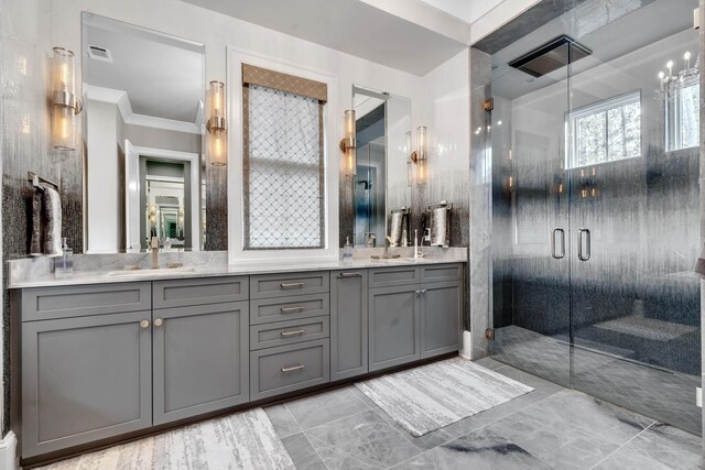 bathroom with vanity, ornamental molding, and a shower with shower door