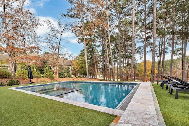 view of pool featuring a yard