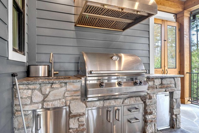 view of patio with a grill, area for grilling, and sink