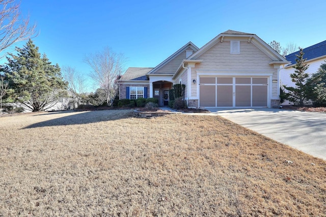 view of front of house featuring a garage and a front lawn