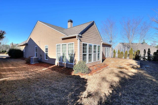 rear view of house with a patio and central AC unit