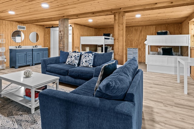 living room featuring recessed lighting, wooden ceiling, wood walls, and light wood-type flooring