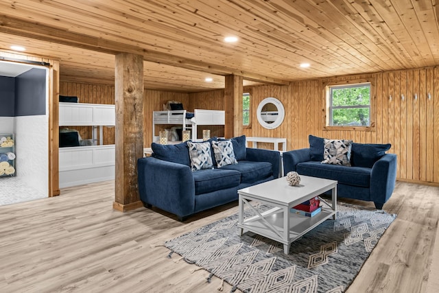 living room with wood walls, wood ceiling, and light wood-style flooring