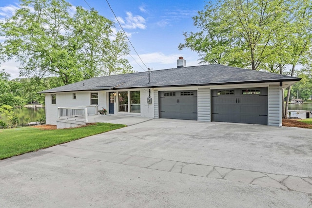 single story home with a shingled roof, an attached garage, a front lawn, a chimney, and driveway