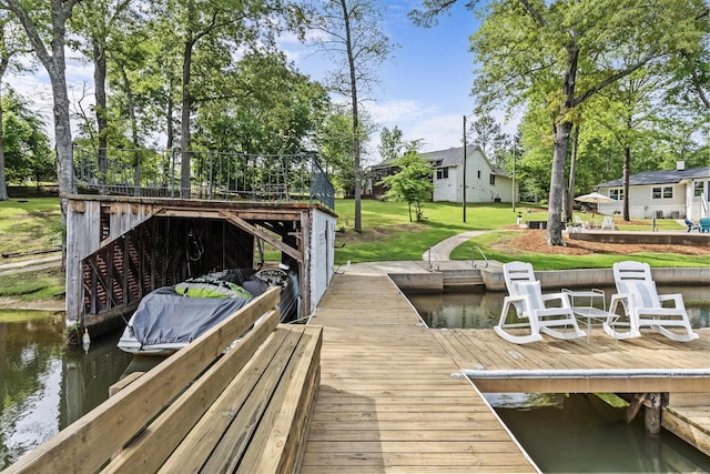 dock area featuring a lawn and a water view