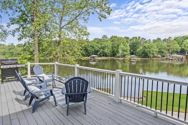 wooden terrace featuring a water view and area for grilling