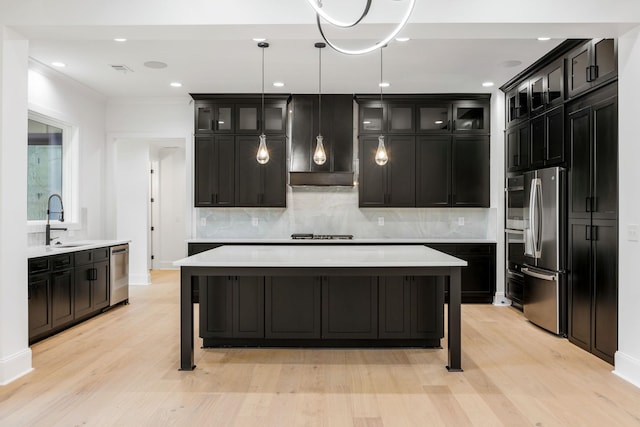 1050 Carnoustie Dr, Greensboro, GA 30642 - kitchen with appliances with stainless steel finishes, light wood-style flooring, backsplash, glass insert cabinets, and recessed lighting
