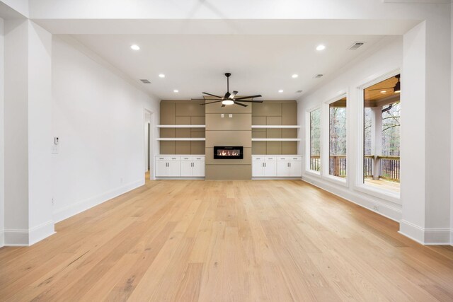 1050 Carnoustie Dr, Greensboro, GA 30642 - unfurnished living room with a ceiling fan, a fireplace, baseboards, light wood-type flooring, and recessed lighting