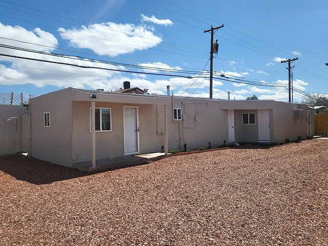 back of house featuring a wall mounted AC