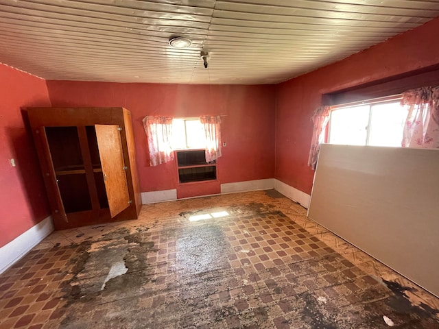 tiled empty room with a wealth of natural light