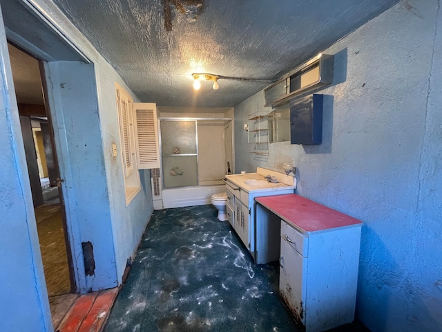 interior space with a textured ceiling and sink