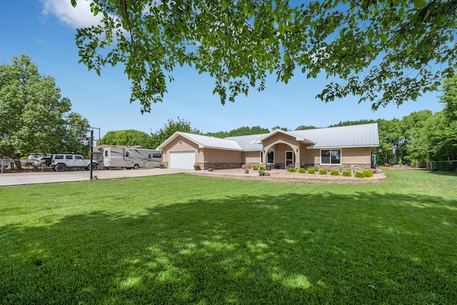 single story home featuring a front lawn and a garage