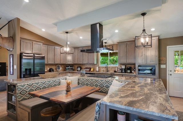 kitchen featuring appliances with stainless steel finishes, a kitchen island, backsplash, decorative light fixtures, and island range hood