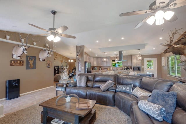 living room featuring light tile floors, ceiling fan, and vaulted ceiling