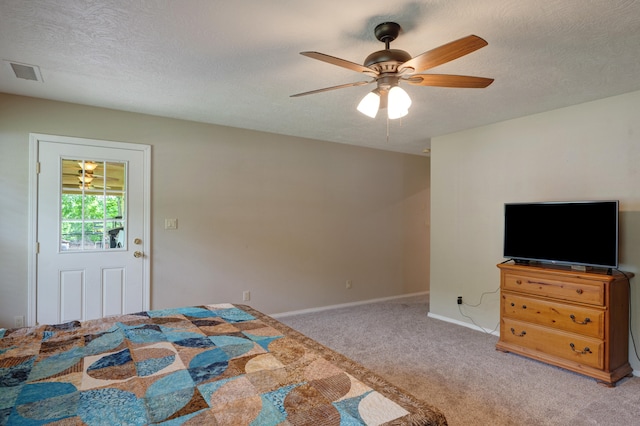 carpeted bedroom with a textured ceiling and ceiling fan