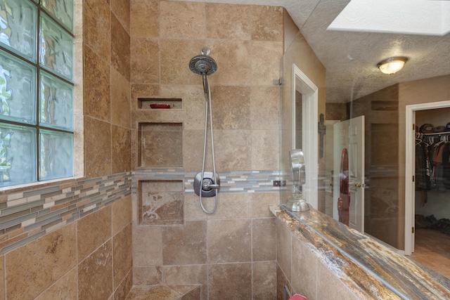 bathroom with tiled shower