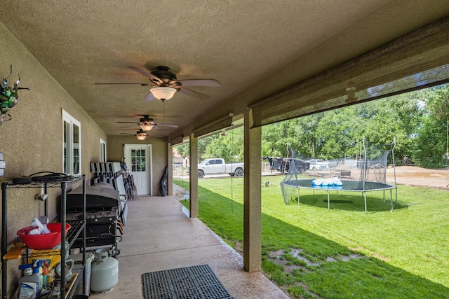 view of terrace with ceiling fan and a trampoline