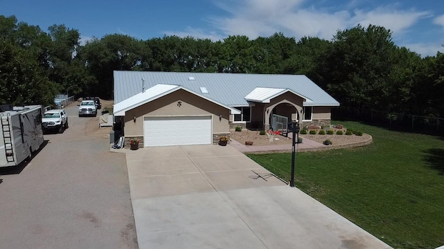 ranch-style home featuring a front lawn and a garage