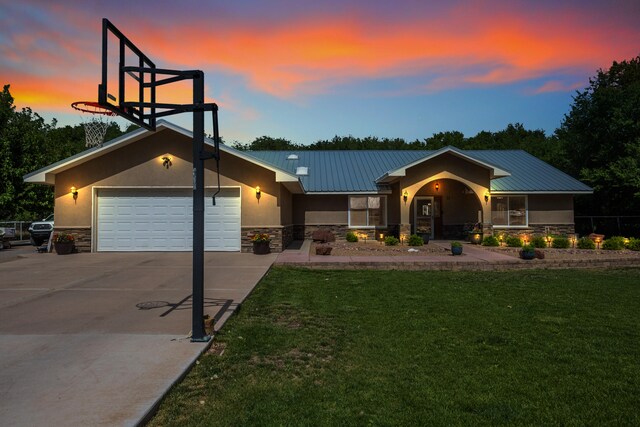 view of front facade featuring a lawn and a garage