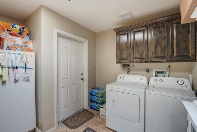 washroom with hookup for a washing machine, independent washer and dryer, light tile floors, and cabinets