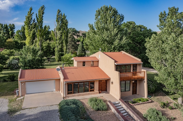 view of front of house featuring a balcony and a garage