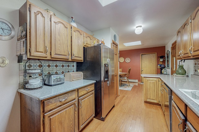 kitchen with backsplash, stainless steel fridge with ice dispenser, a baseboard heating unit, and light wood-type flooring