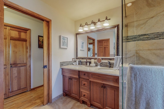 bathroom with tile floors and double vanity