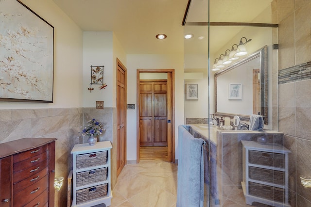 bathroom with vanity, tile flooring, and tile walls