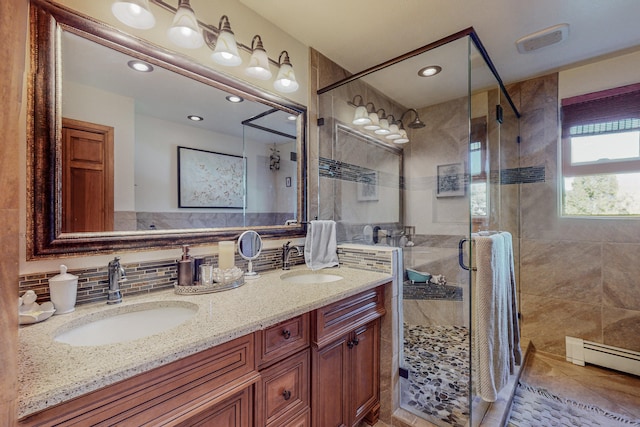 bathroom with double sink, backsplash, a shower with door, tile flooring, and oversized vanity