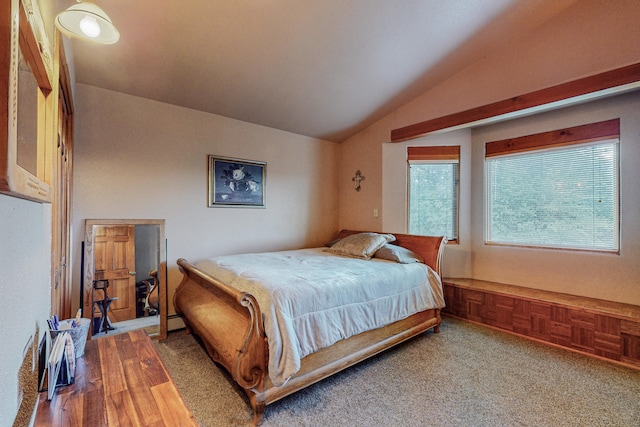 bedroom with lofted ceiling and light colored carpet