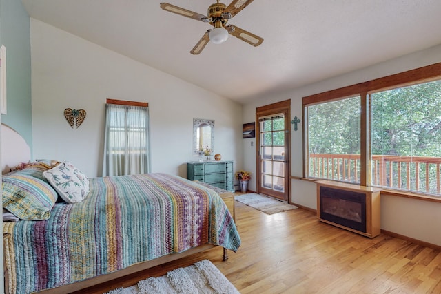 bedroom with ceiling fan, lofted ceiling, and light wood-type flooring