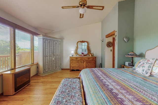 bedroom with light hardwood / wood-style floors, ceiling fan, and lofted ceiling