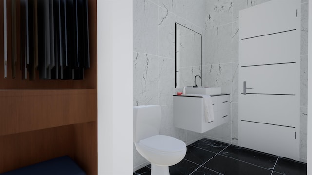 bathroom with tile walls, vanity, tile patterned floors, and toilet