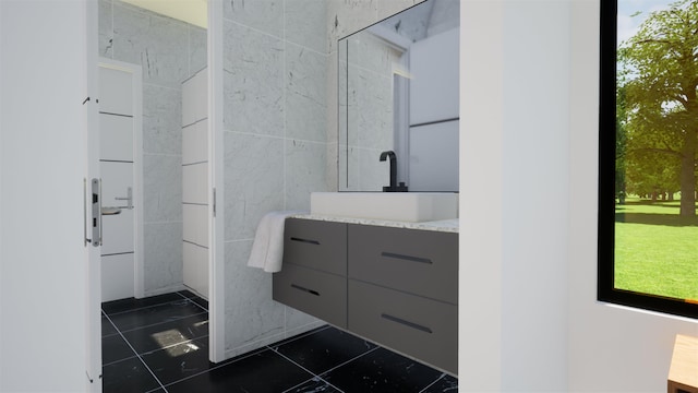 bathroom with vanity, tile patterned flooring, and tile walls