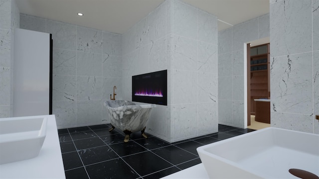 bathroom featuring tile patterned floors, sink, and tile walls